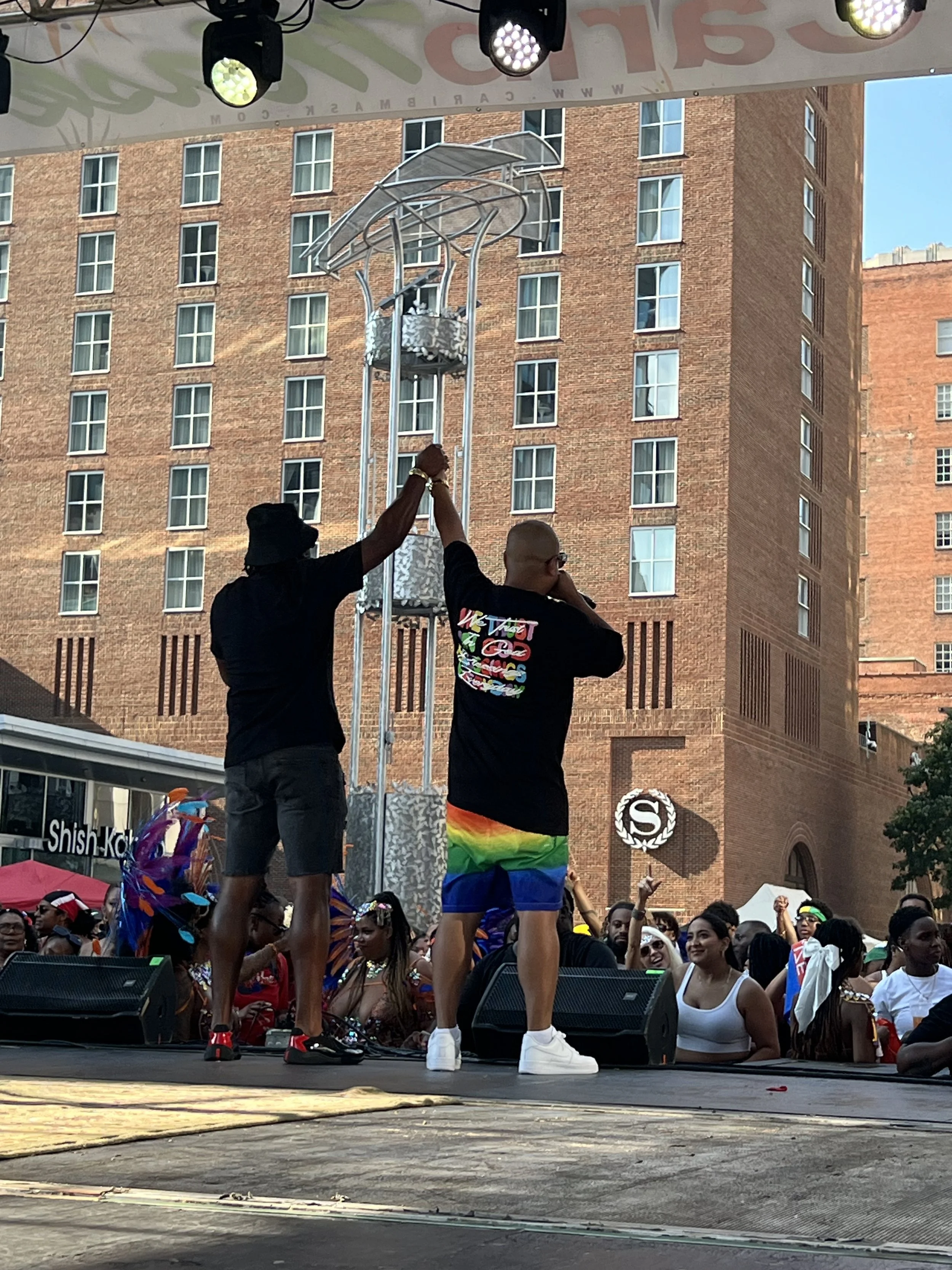 Caribmask-Raleigh-performers-holding-raised-hands